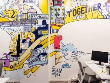 Office wall with illustrations, company values language