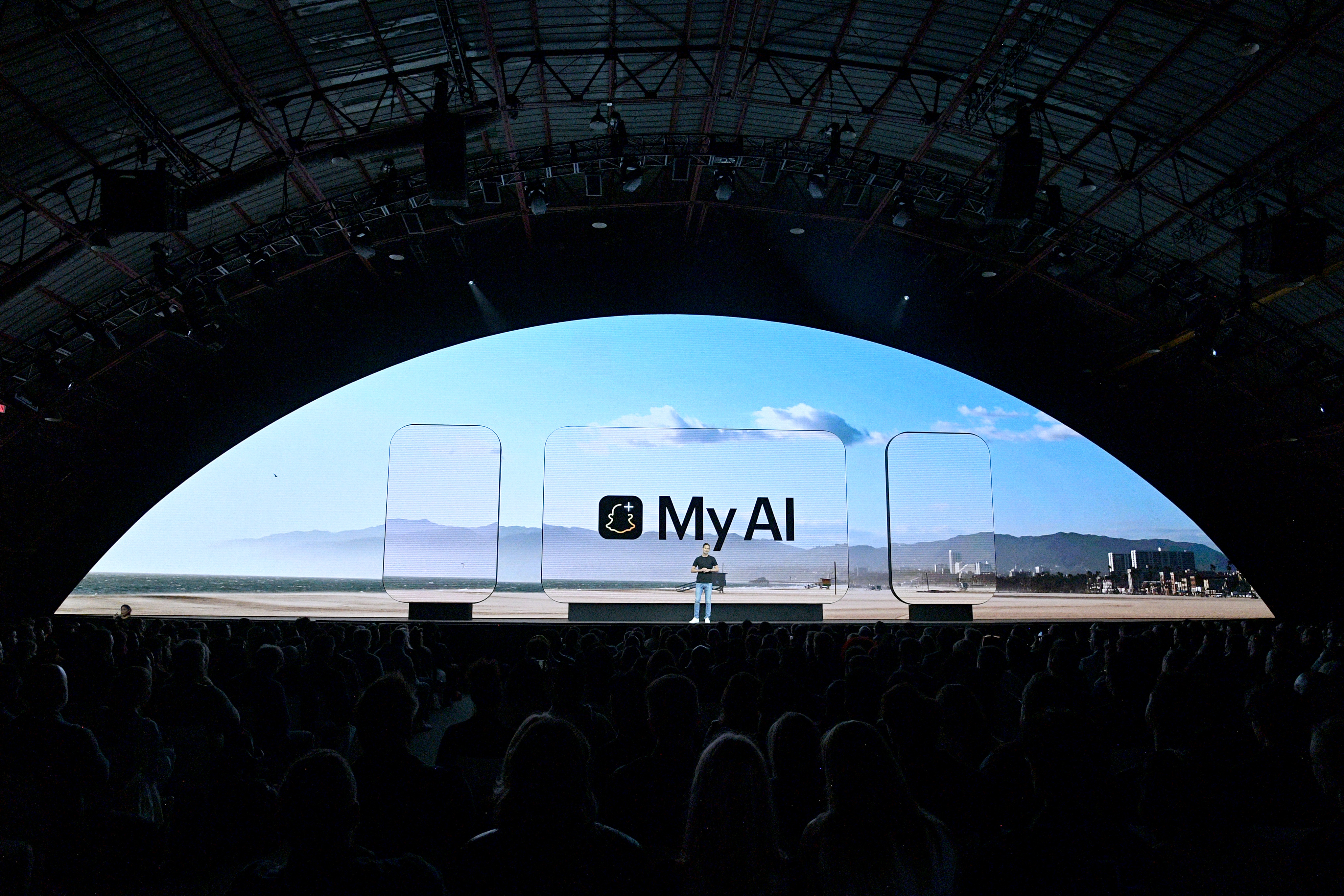 Photo of keynote stage at Barker Hangar with "My AI" on the large, semicircle screen