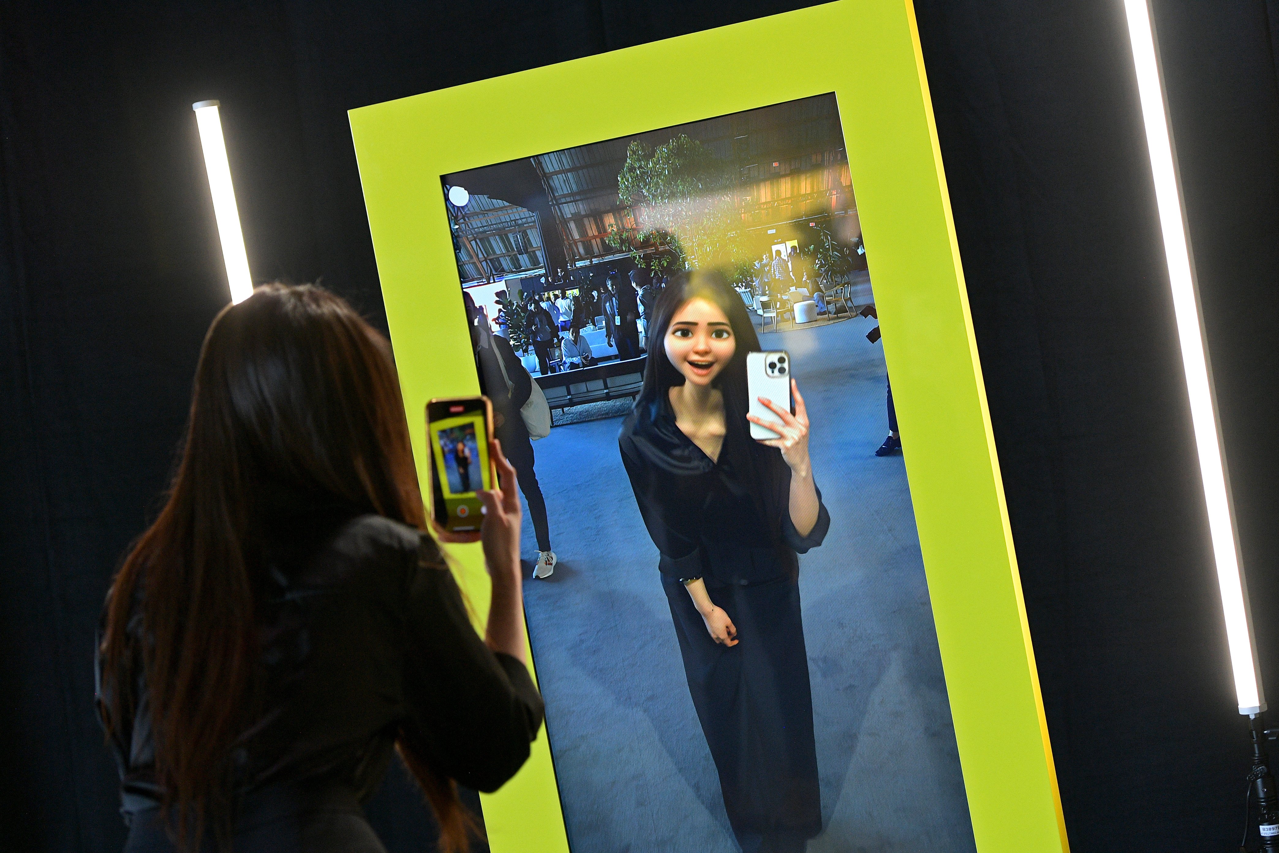 Photo of attendee using the AR cartoon mirror lens
