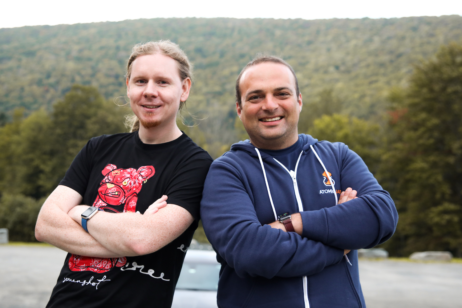 AtomicJar co-founder Sergei Egorov, left, and Eli Aleyner stand shoulder to shoulder outside.