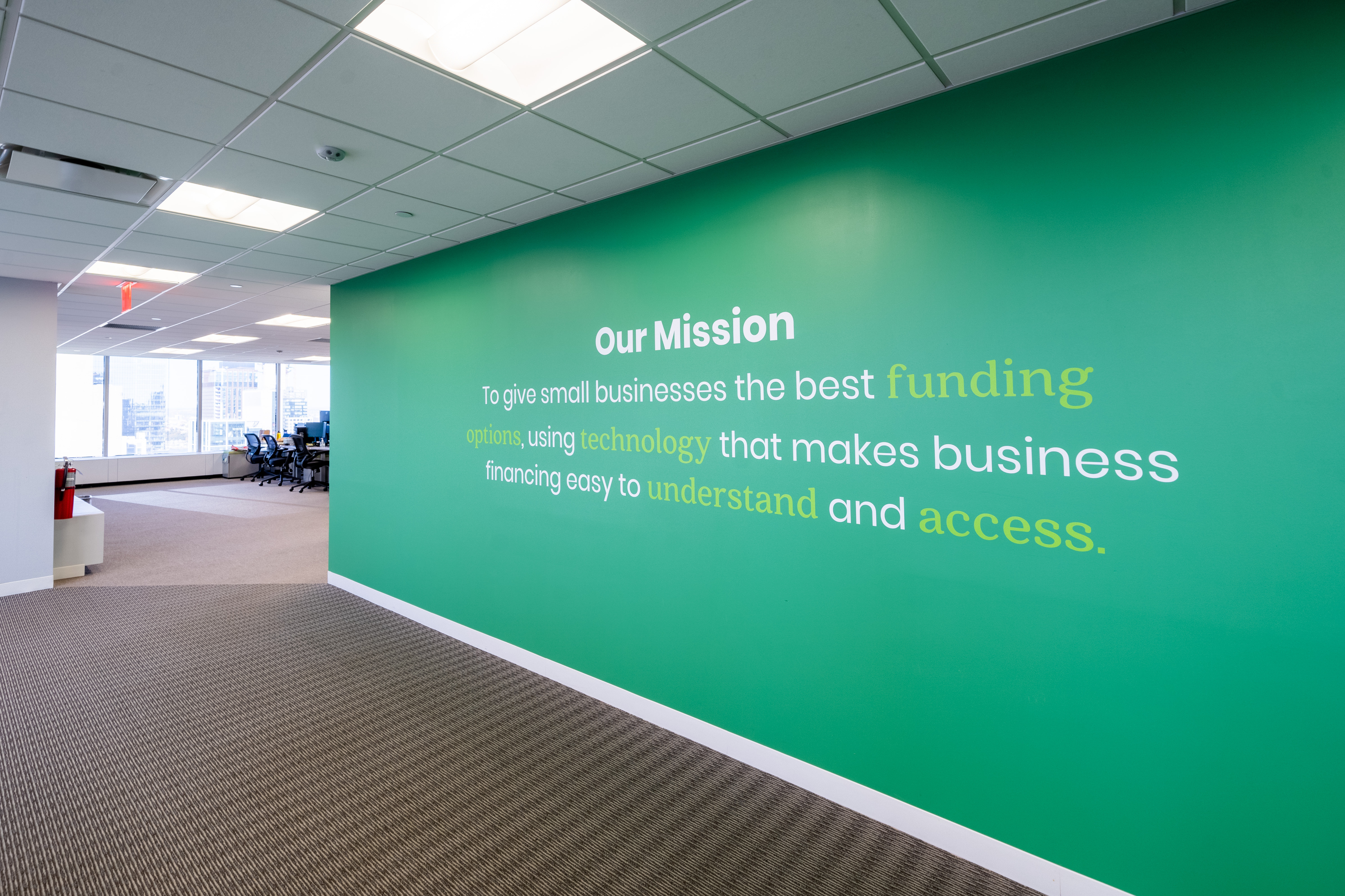 Biz2Credit’s mission statement on a green wall in its office