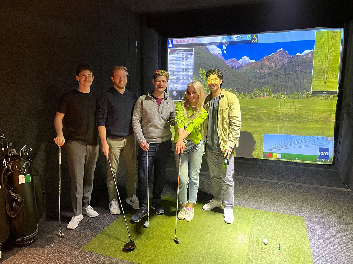 CompStak team members at an indoor golf event