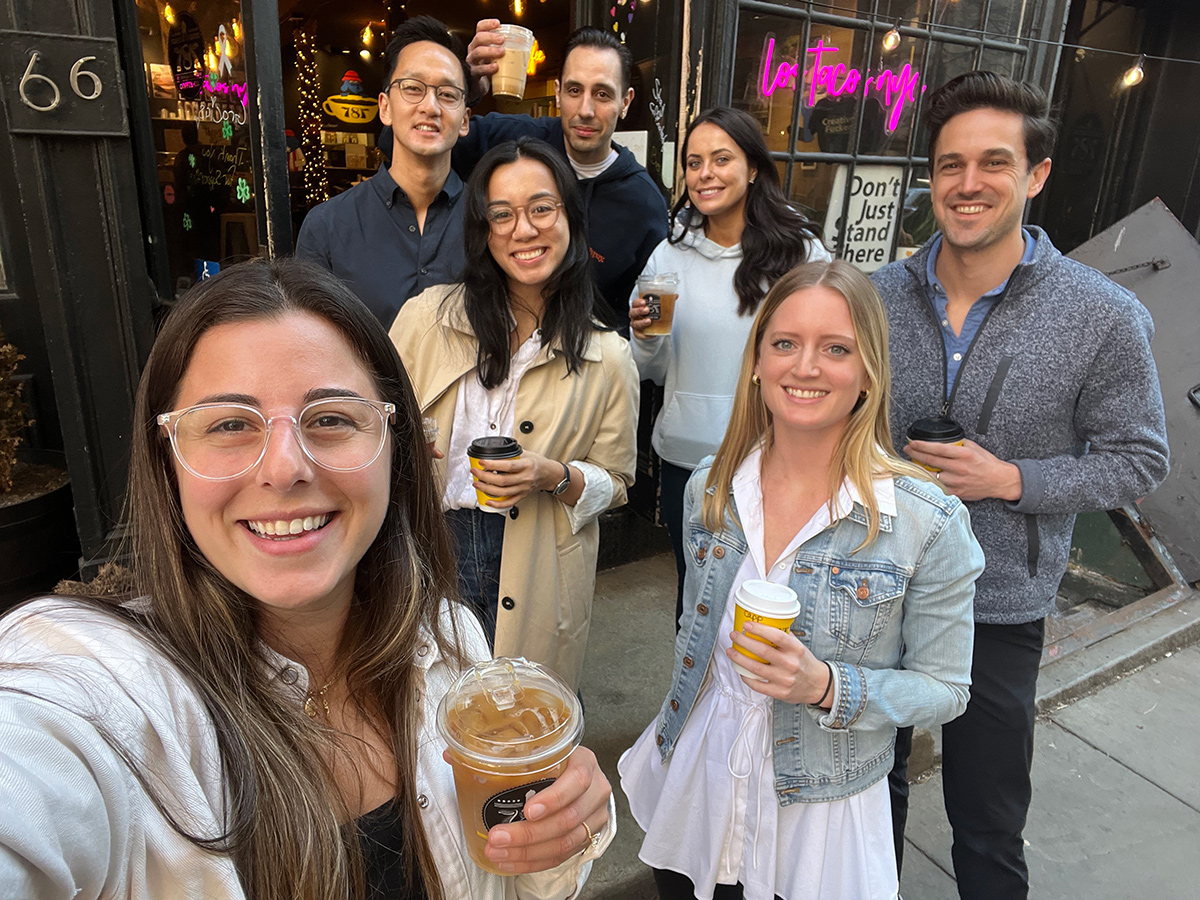 DailyPay team members group selfie outside of a coffee shop