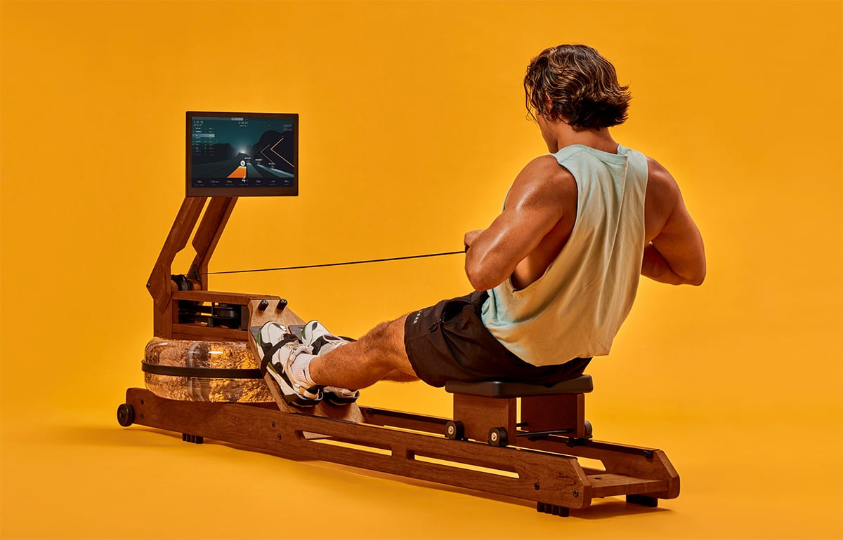 A man working out on a Ergatta rower