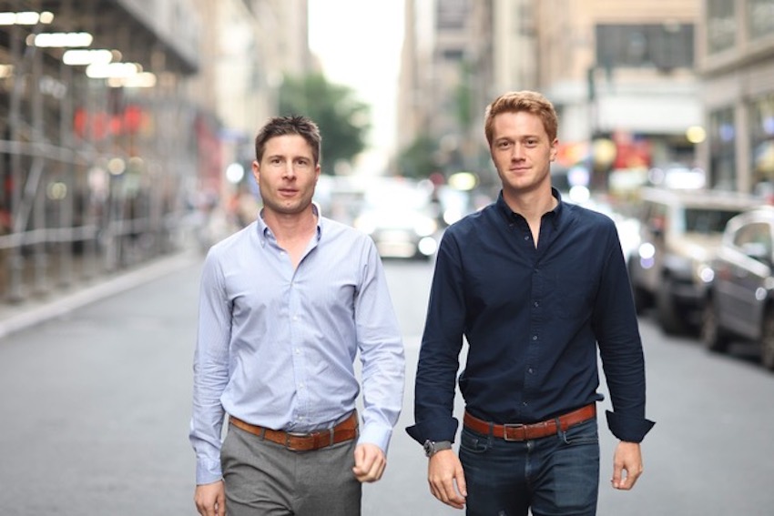 EvolutionIQ co-founders Tomas Vykruta (left) and Michael Saltzman (right) walk down the middle of a street.