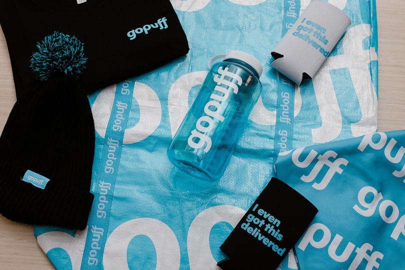 Gopuff swag including a t-shirt, water bottle, beanie, and more