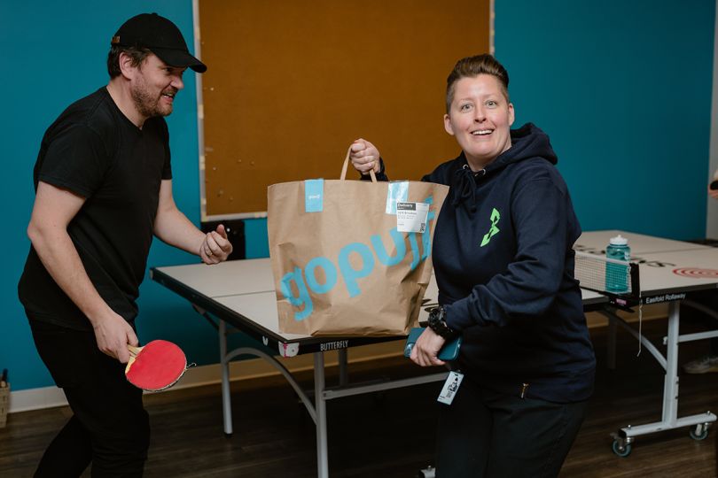 Gopuff team member holding a bag with an order ready for delivery