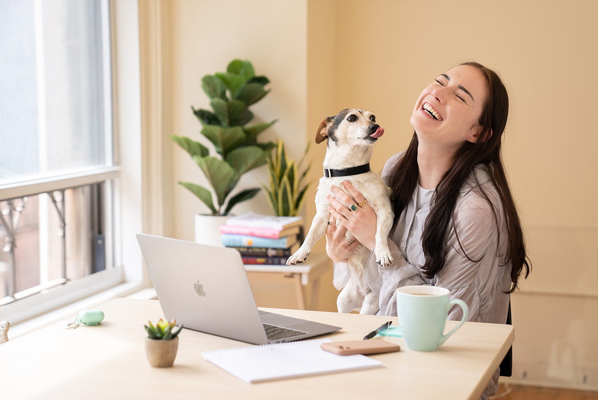 Grow Therapy team member working from home holding a dog