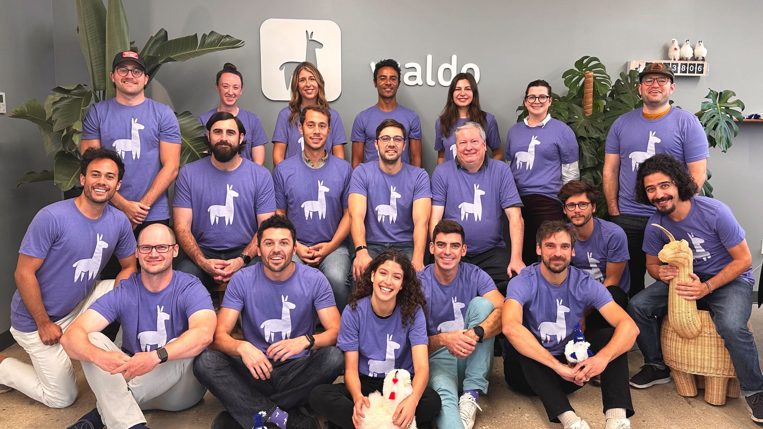 Waldo’s team poses in matching shirts bearing the company’s logo.