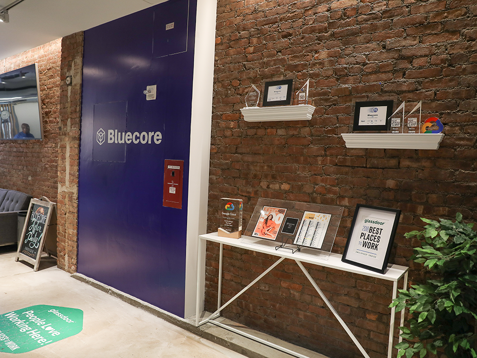 Inside the Bluecore office with the company logo on the wall