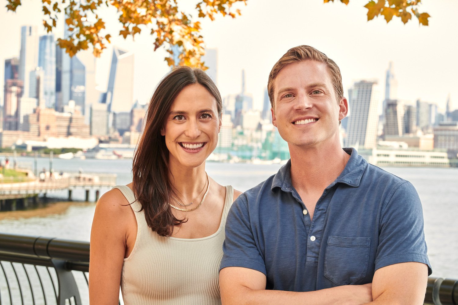 Marker Learning co-founders Emily Yudofsky (left) and Stefan Bauer (right) post for a photo in front of the NYC skyline.
