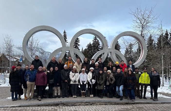 photo of a team infront of Olympic rings