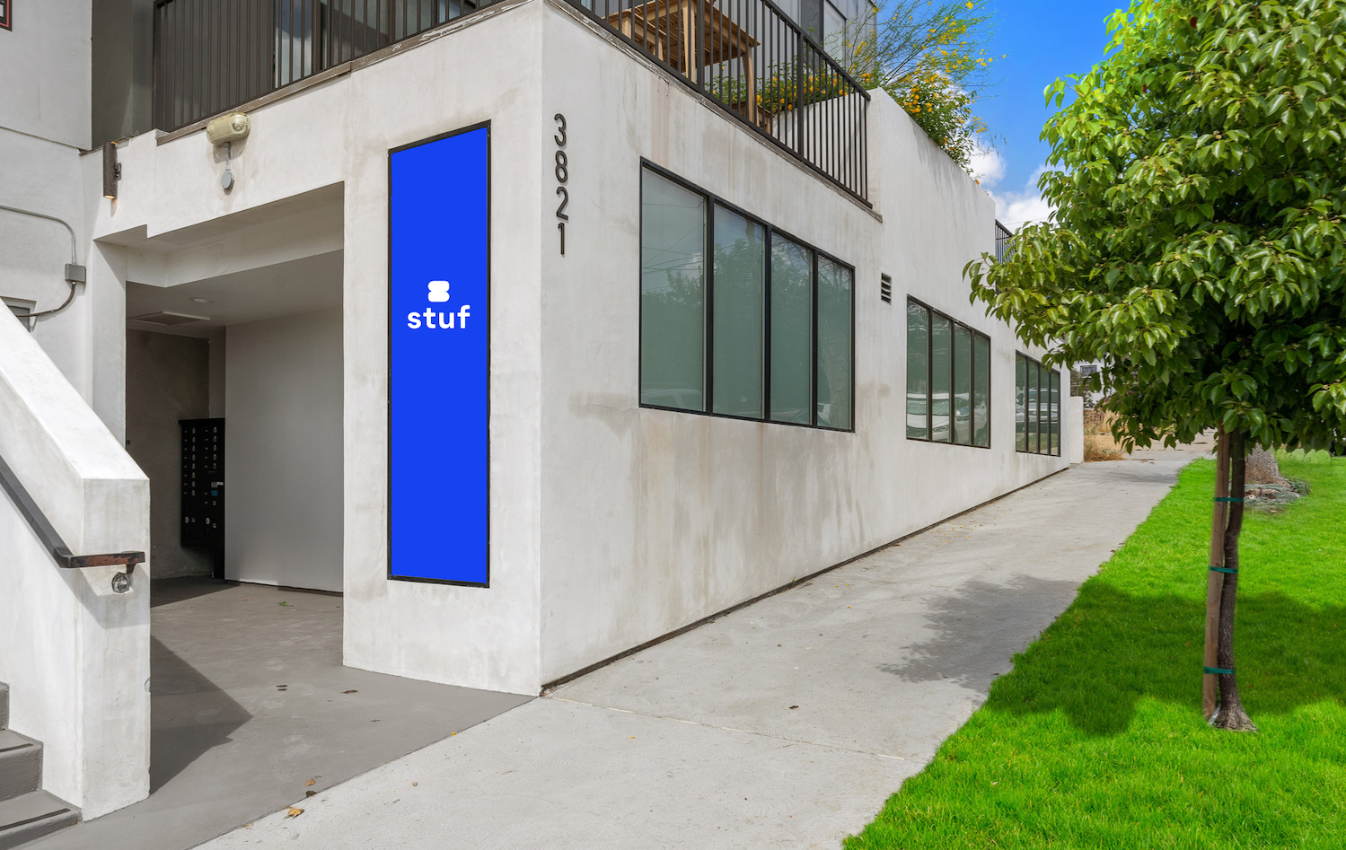 Stuf's logo on a blue sign affixed to a gray building in Los Angeles' Eagle Rock neighborhood.