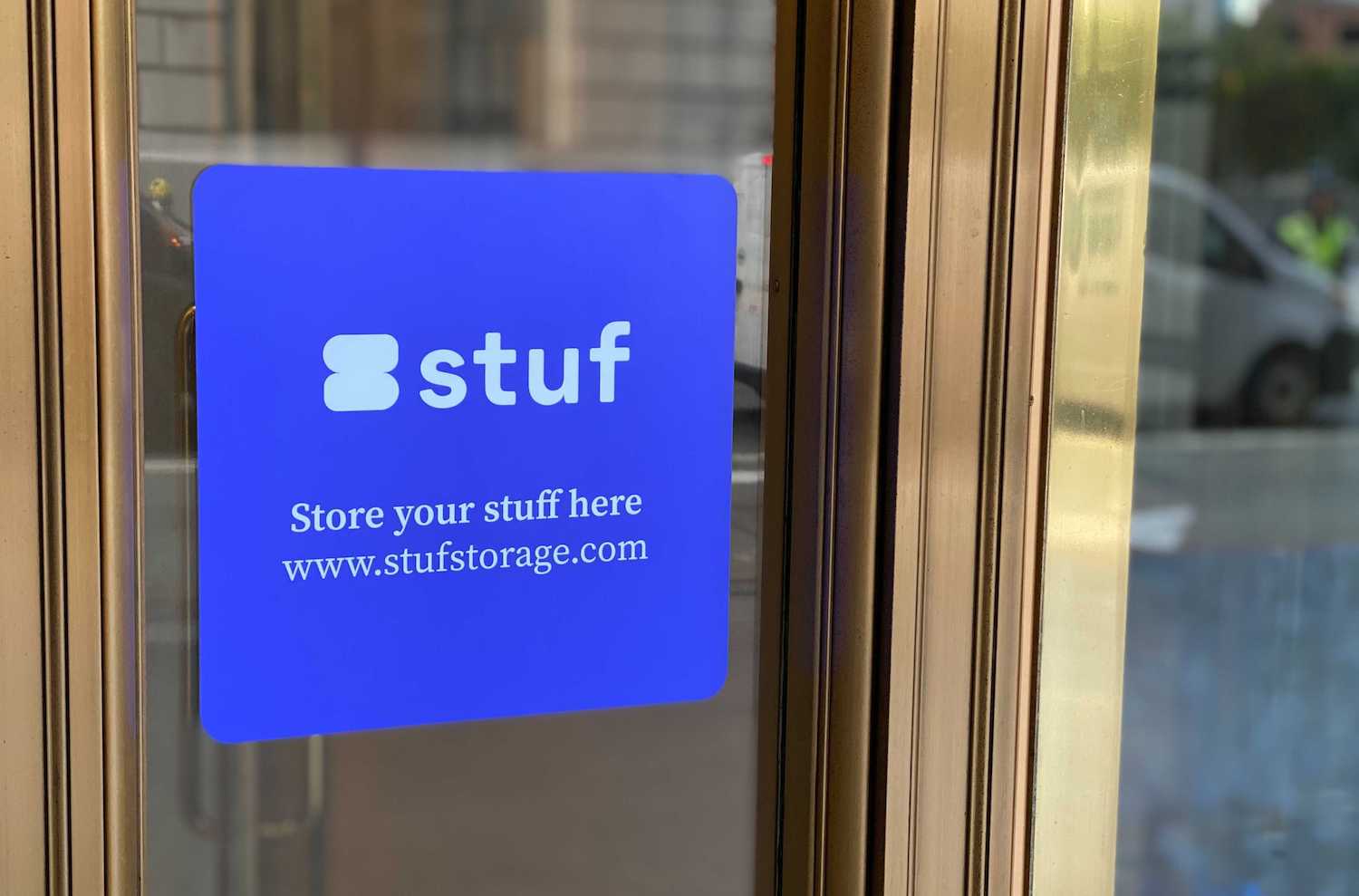 Stuf’s logo on a blue sign affixed to a gray building in San Francisco’s Financial District.