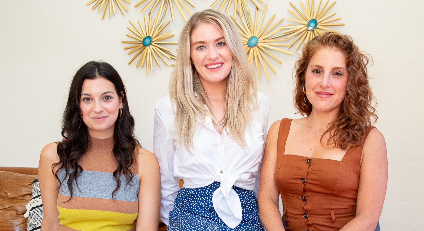 Hey Jane co-founders Gaby Izarra, Kiki Freedman, and Dr. Kate Shaw sit on a couch