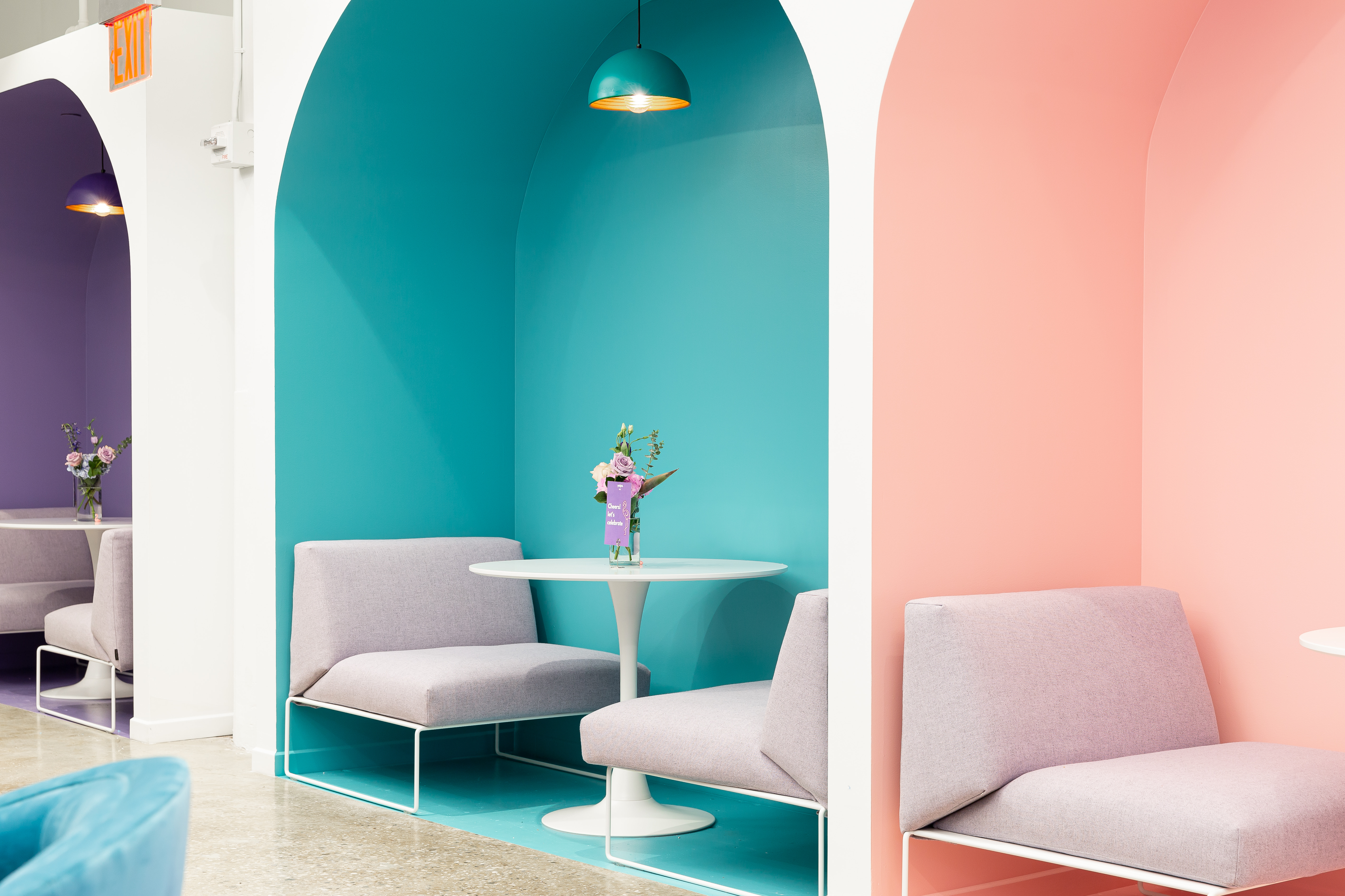Photo of Yotpo’s NYC office with colorful nooks for two-person seating with a table.