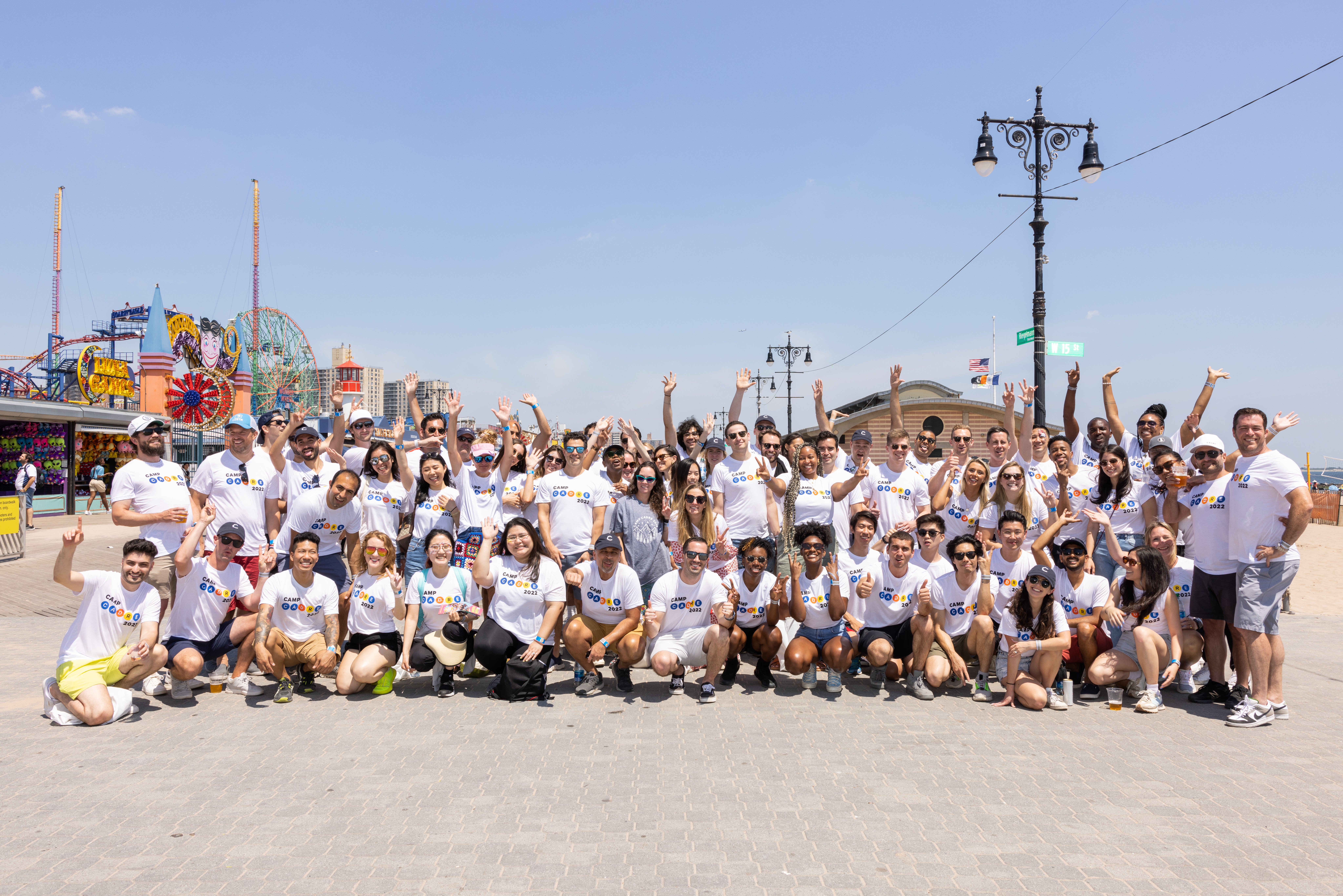 Cadre employees in a group photo at an amusement park. 