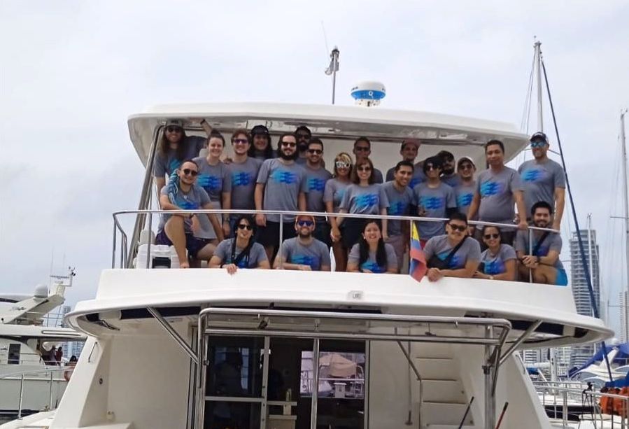 The Cruisebound team poses for a photo on a boat at an offsite gathering.