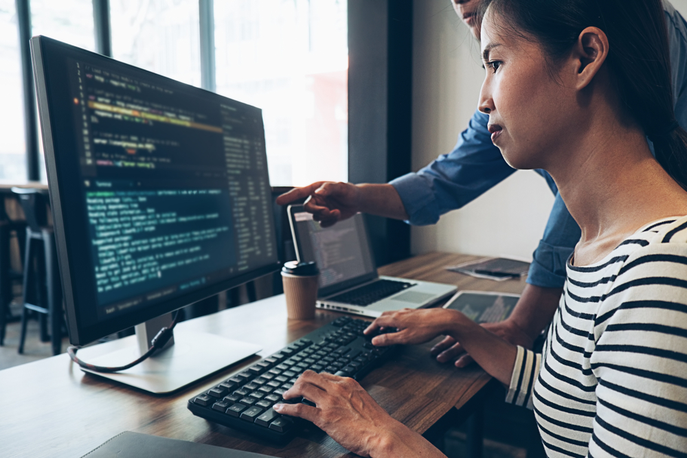 Woman coding at a desktop
