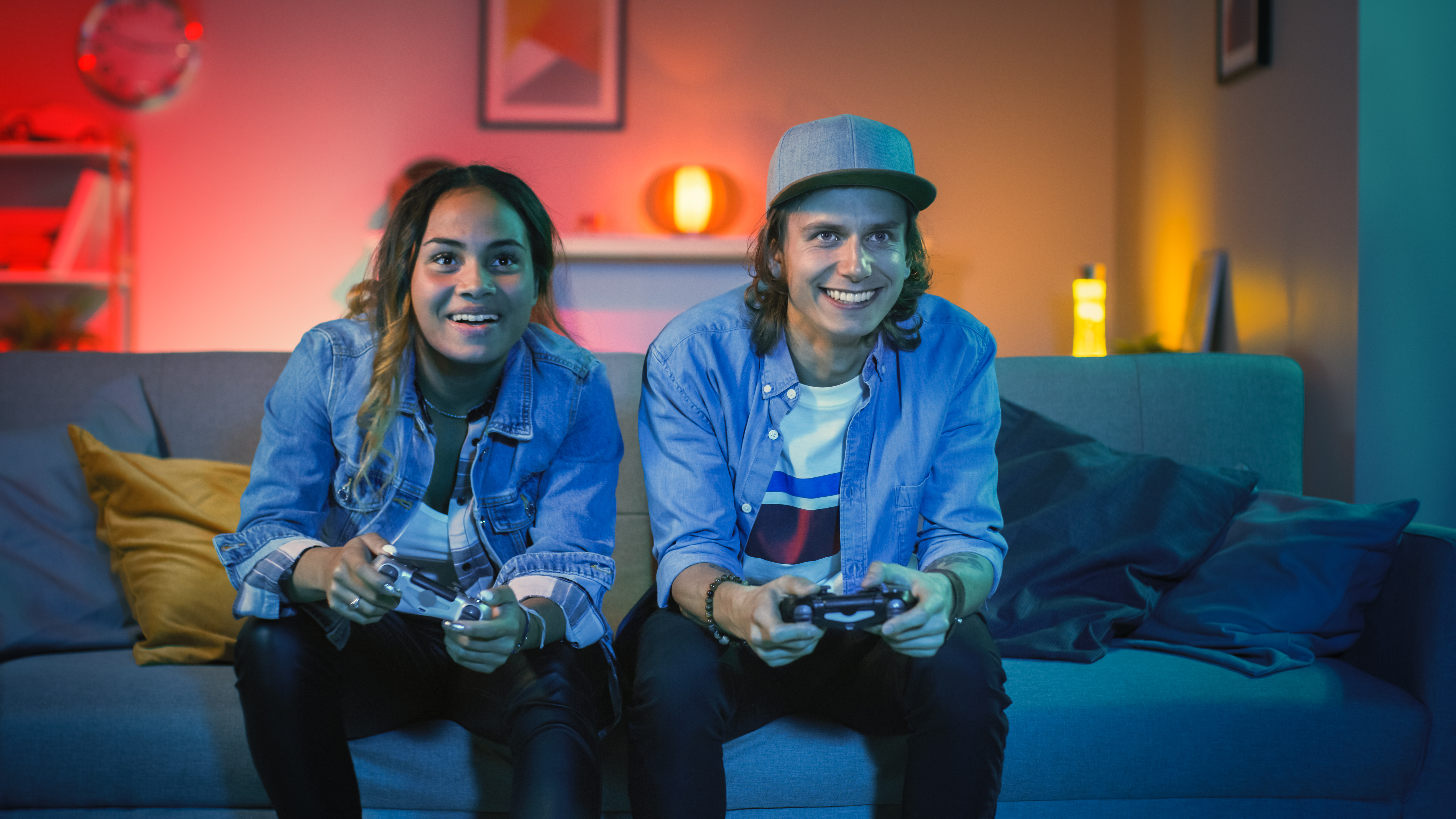 Two gamers holding controllers and playing game
