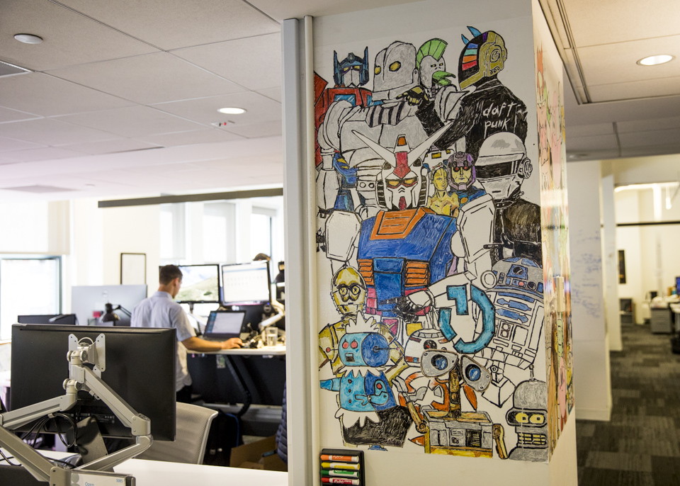 Cartoon and comic illustrations on a wall inside The Trade Desk's NYC office