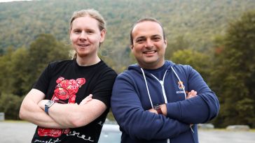 AtomicJar co-founder Sergei Egorov, left, and Eli Aleyner stand shoulder to shoulder outside.