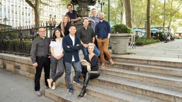 Giant Machines team members pose on the steps to a park in New York City