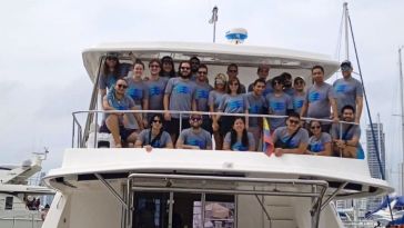 The Cruisebound team poses for a photo on a boat at an offsite gathering.
