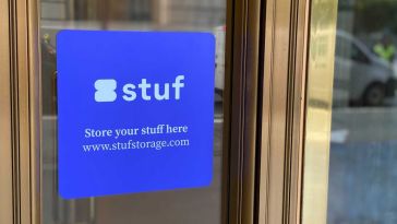 Stuf’s logo on a blue sign affixed to a gray building in San Francisco’s Financial District.