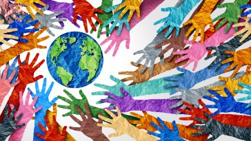 Dozens of paper hands in different colors, all reaching to surround the earth.