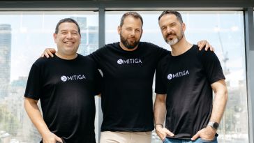Mitiga was co-founded by CTO Ofer Maor, CEO Tal Mozes and COO Ariel Parnes. They are pictured side-by-side in front of a window.