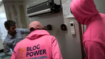 Workers from BlocPower’s NYC Civilian Climate Corps learn about green energy building improvements.